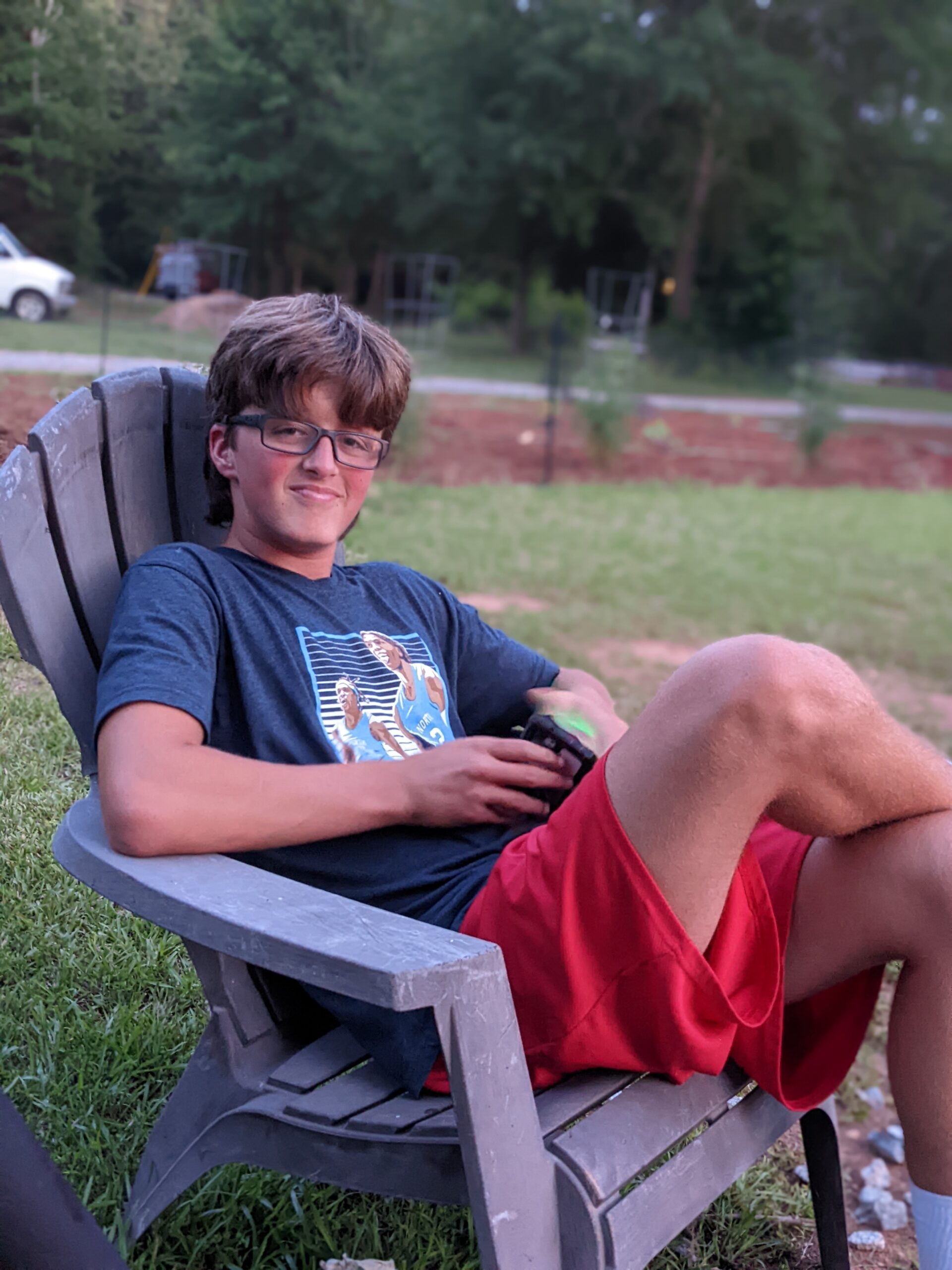 Ben sitting in a chair outside